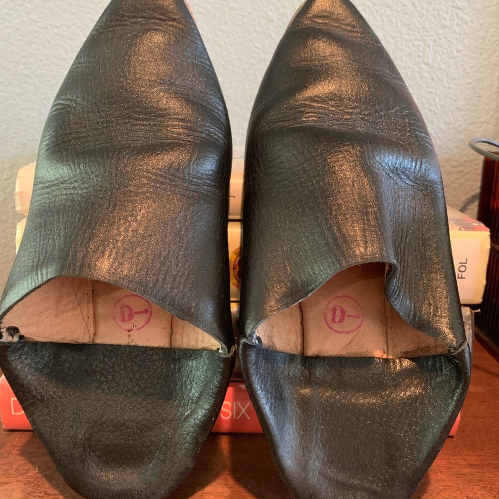 Black slip-on booties. Pointed toe